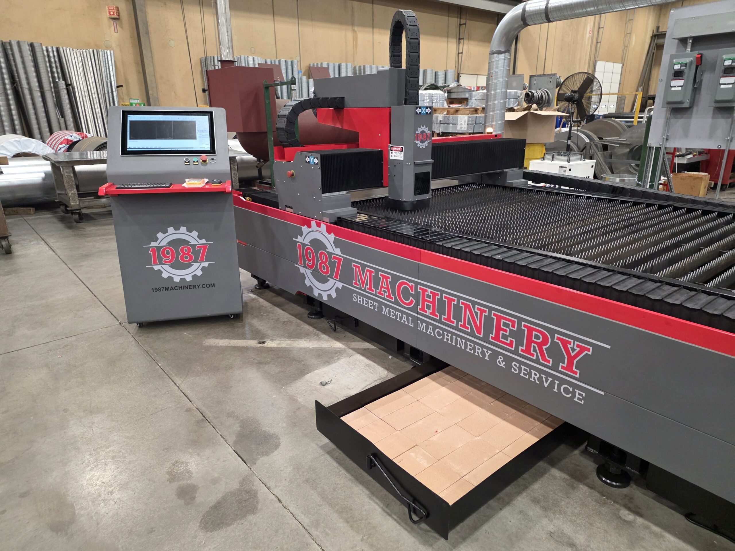 1987 Machinery open table CNC laser cutting machine with control console and pull out debris tray