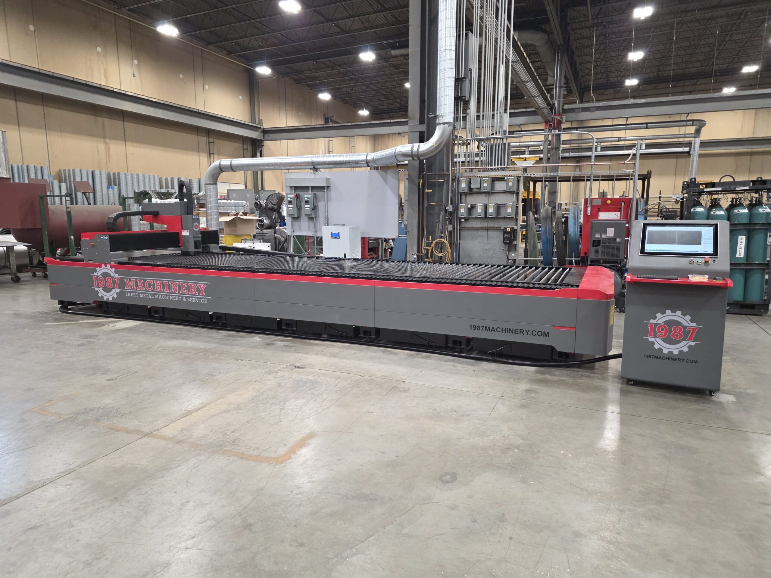 987 Machinery red and gray open table CNC laser cutting machine in industrial workshop