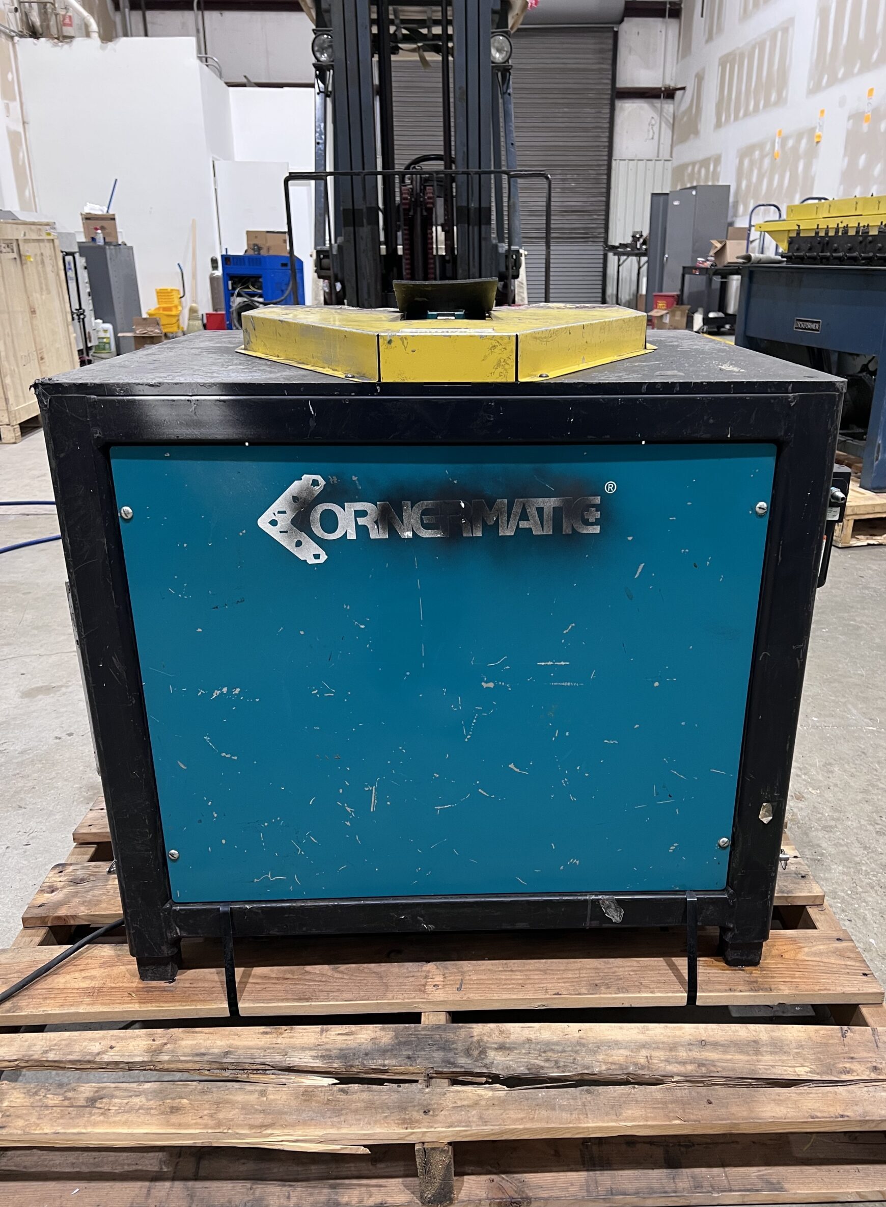 Front view of Iowa Precision Cornermatic Plus HVAC ductwork corner inserter machine on pallet in fabrication shop